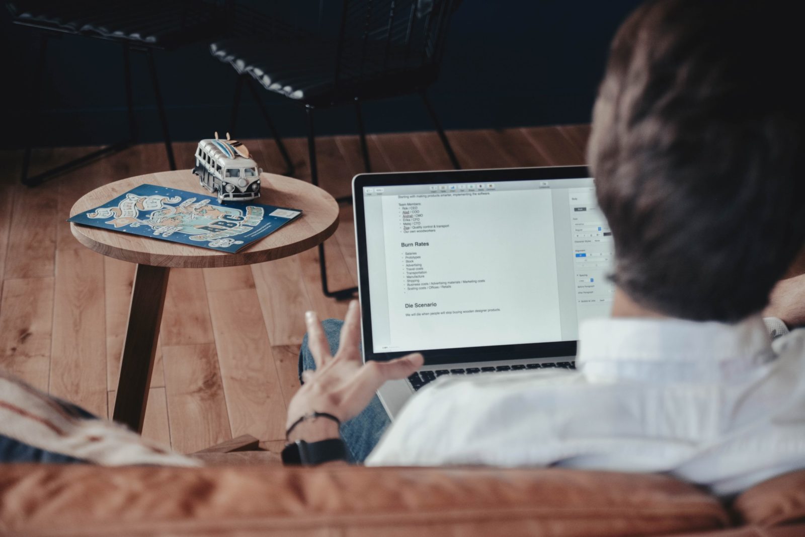 man writing on laptop