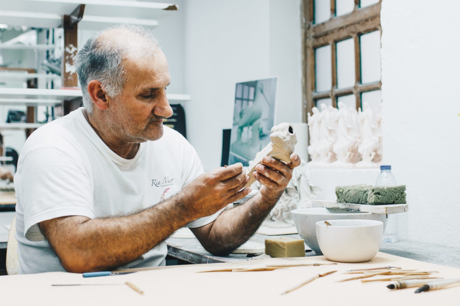 man sculpting in studio