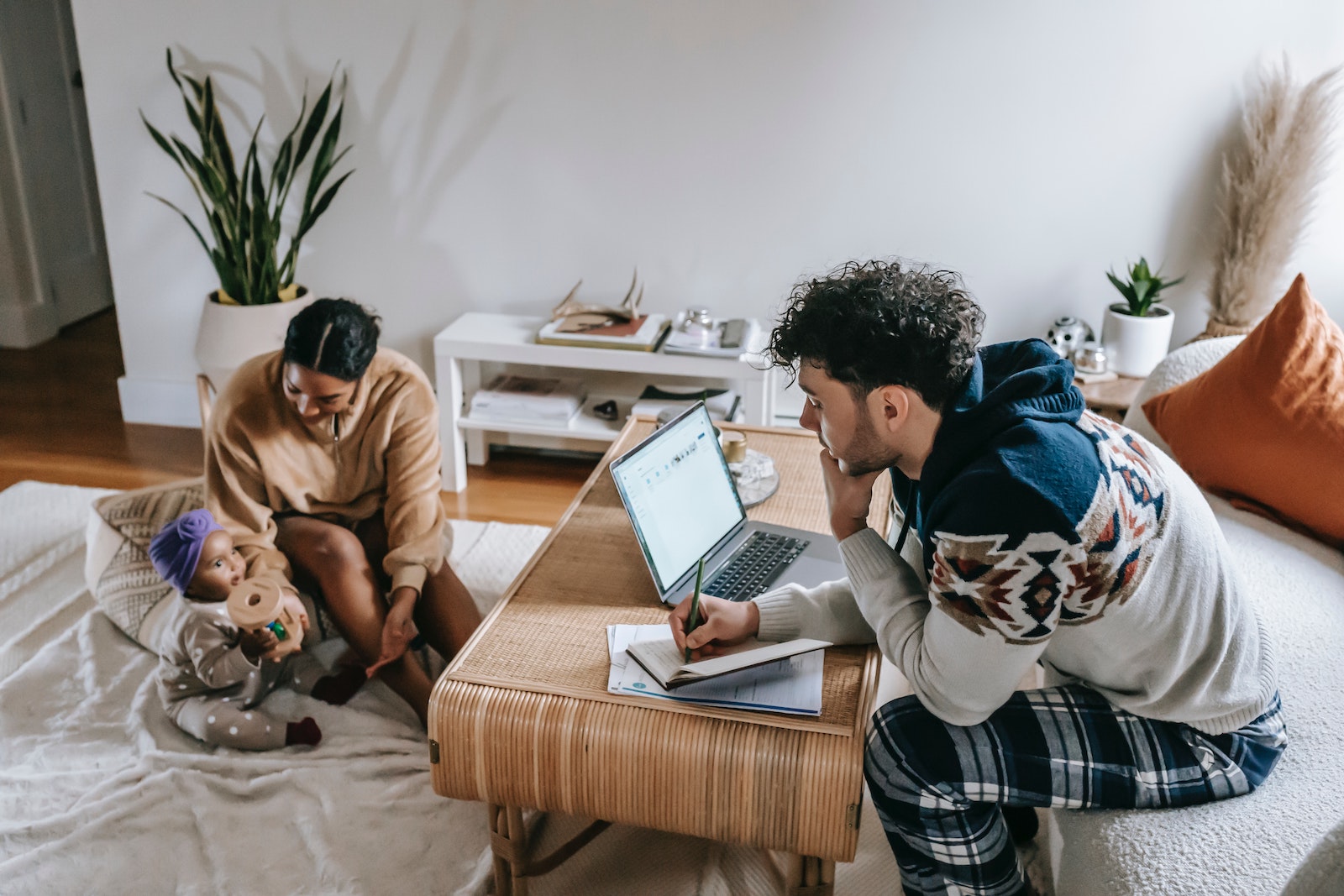 man on computer with family