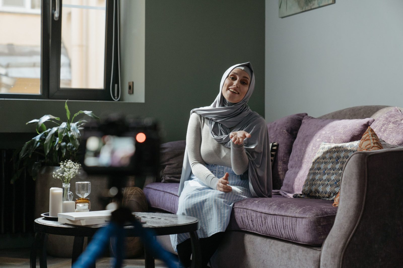 woman talking to camera on couch