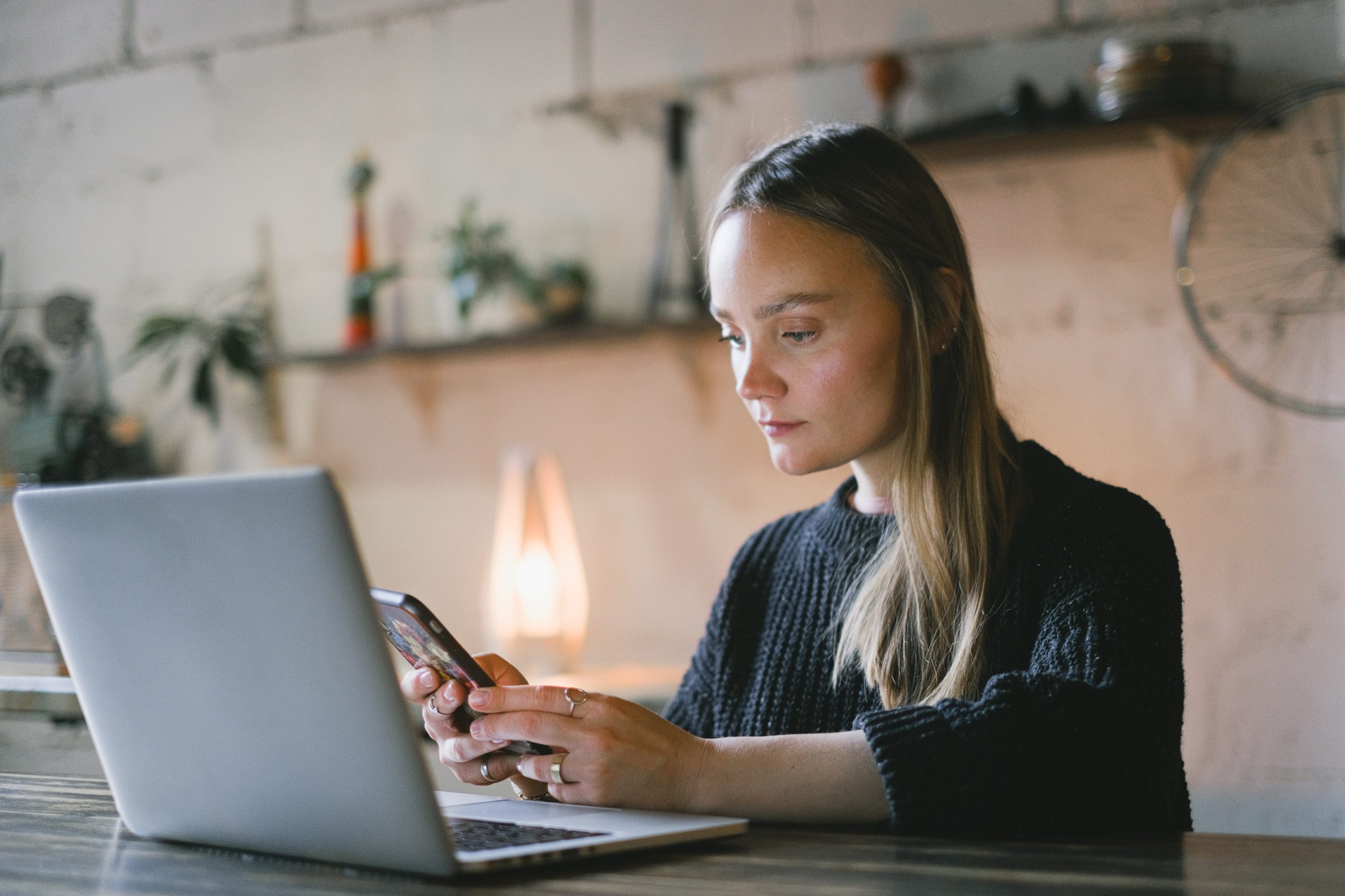 woman on computer and phone