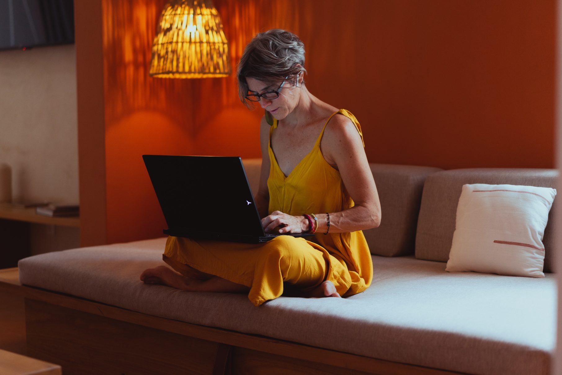 woman working on bed at computer