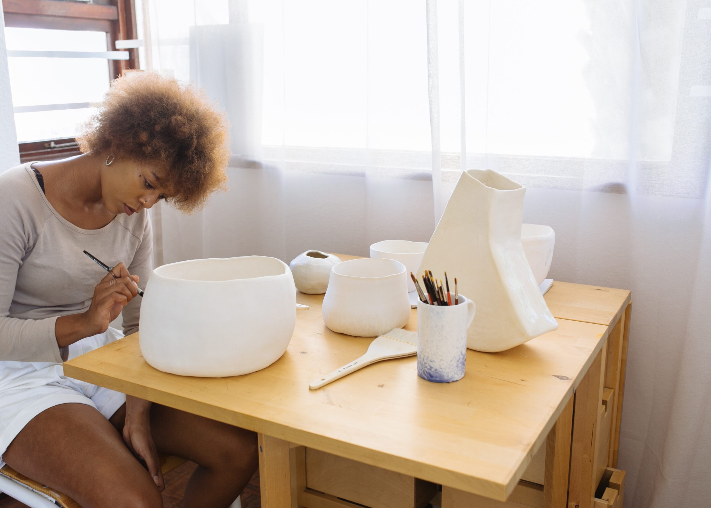 artist painting a pot