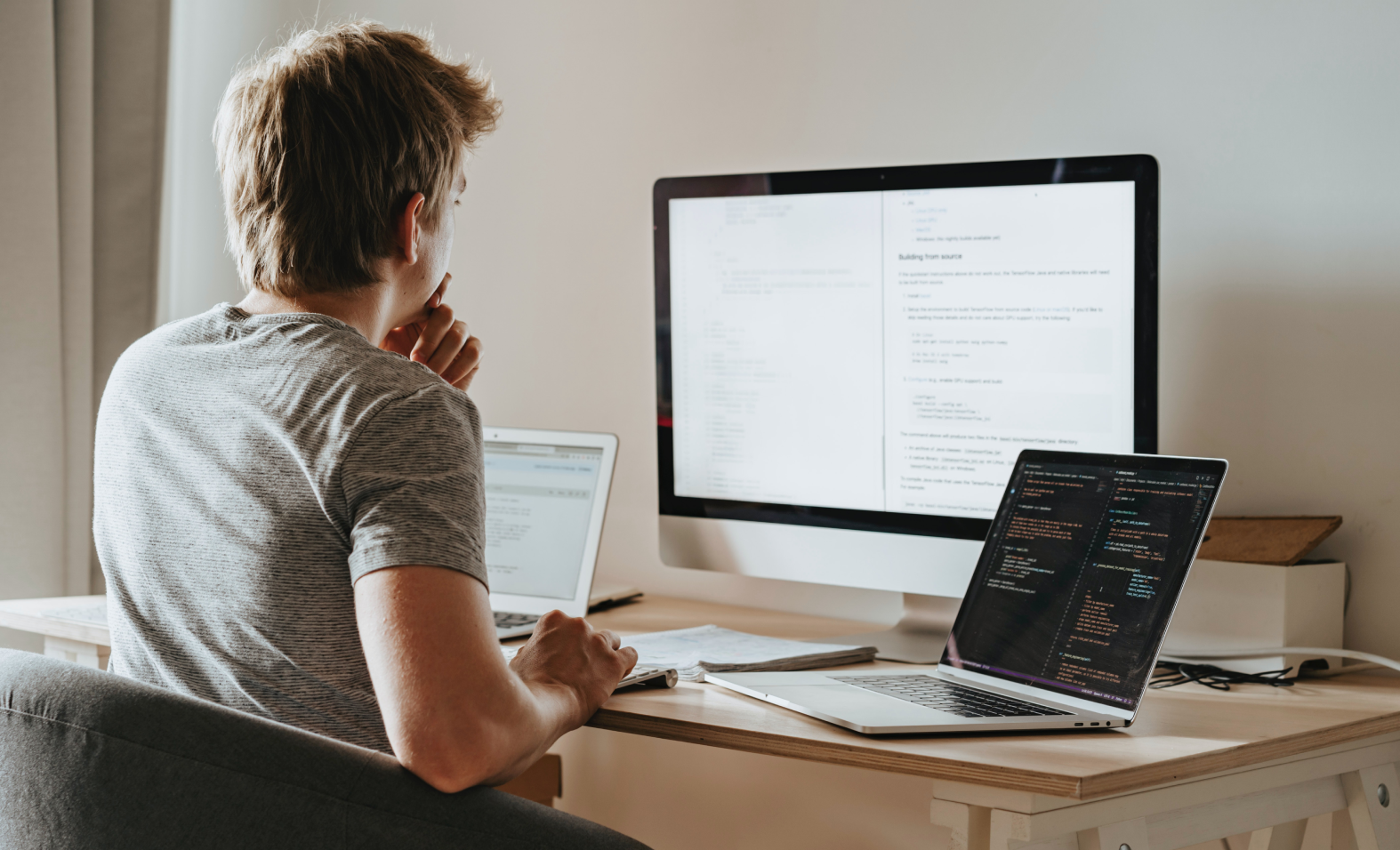 man looking at computers