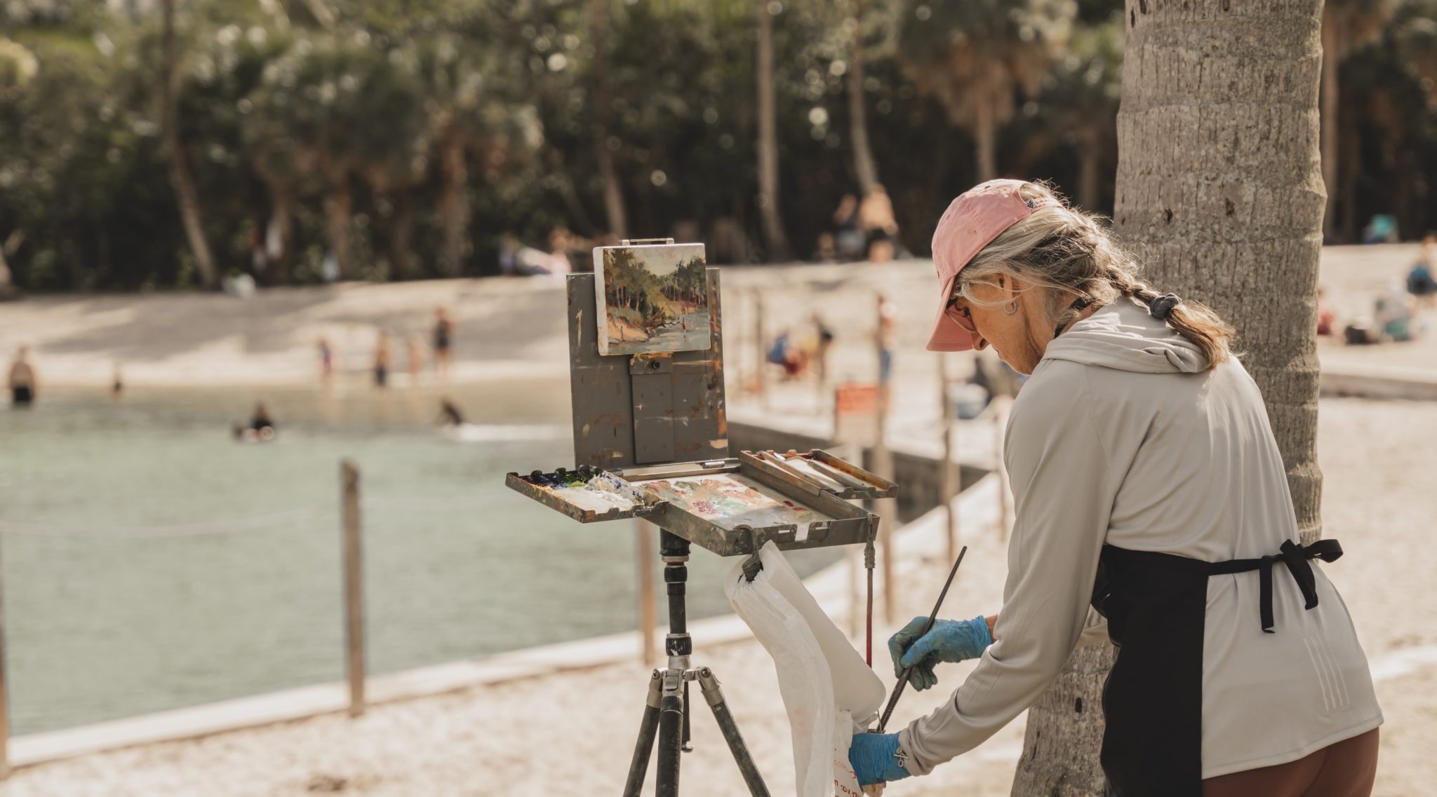 Woman painting on the beach