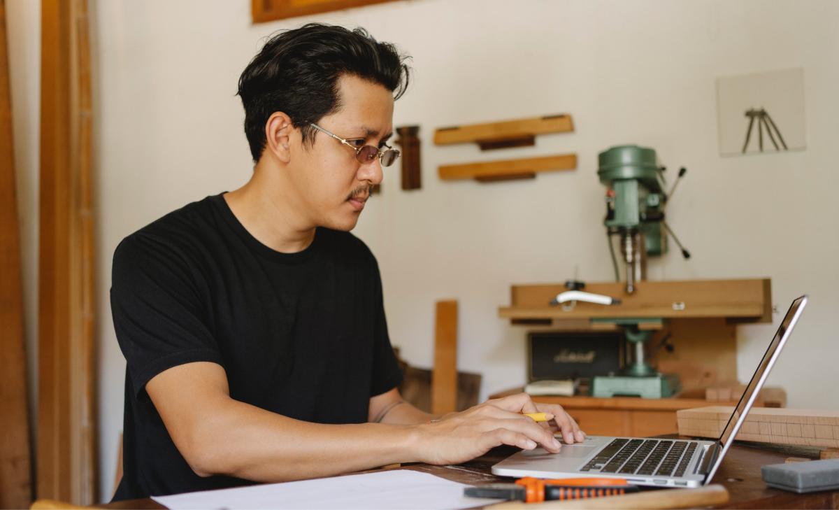 man managing online community engagement at desk