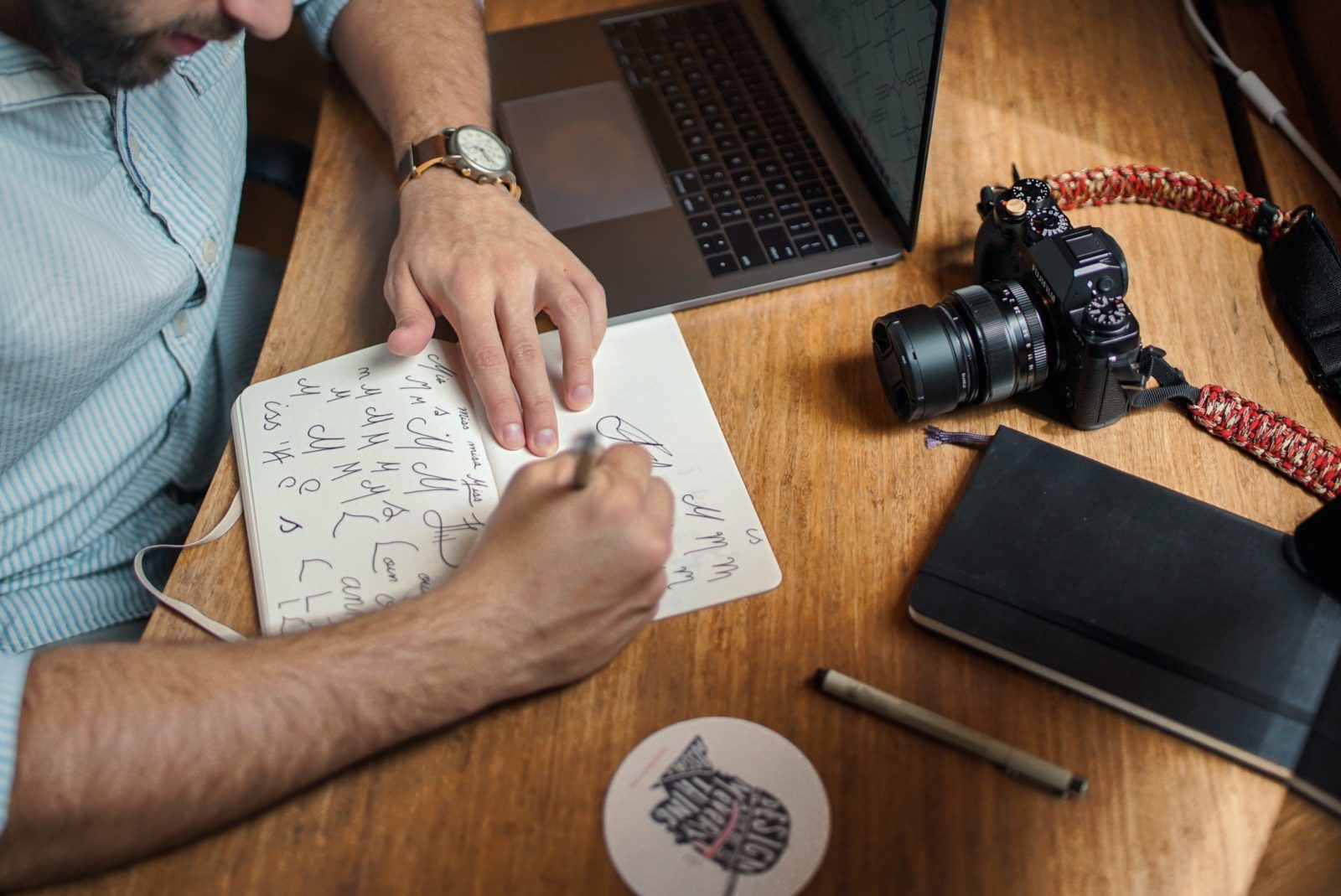 man writing in notebook