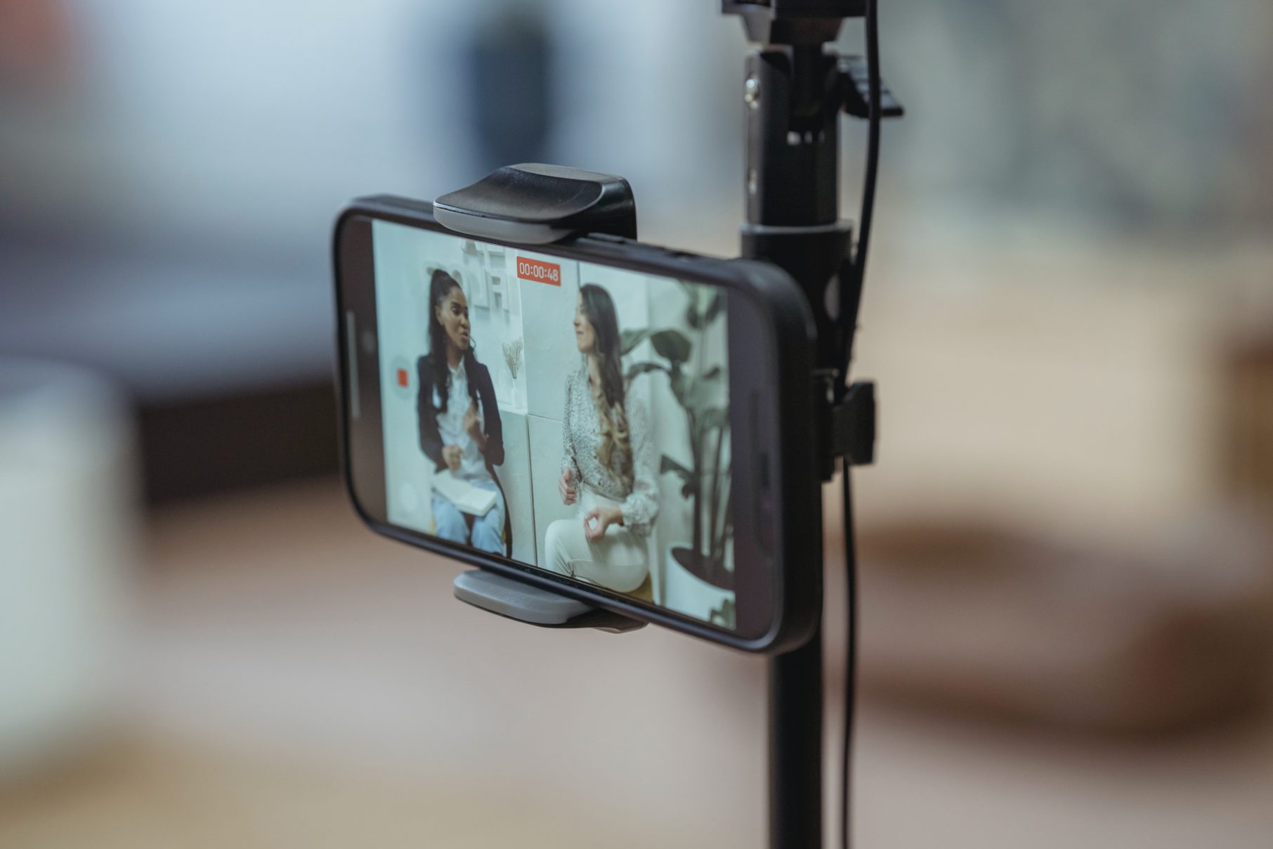 two woman filming video on phone