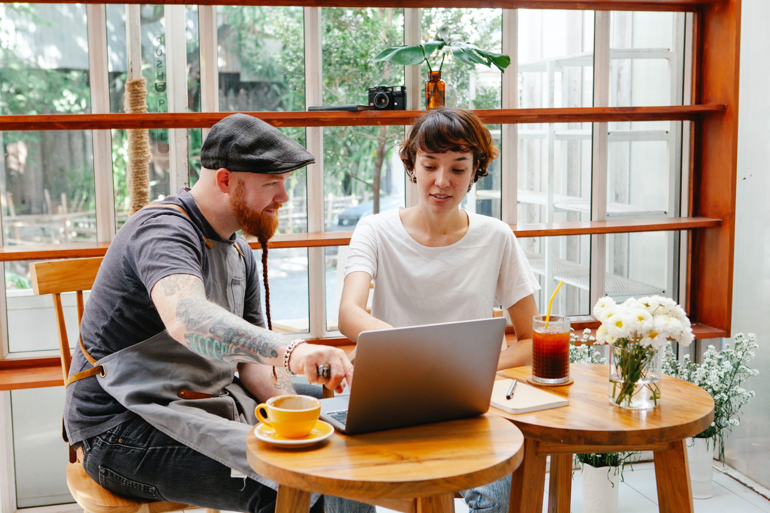 two creators working in cafe