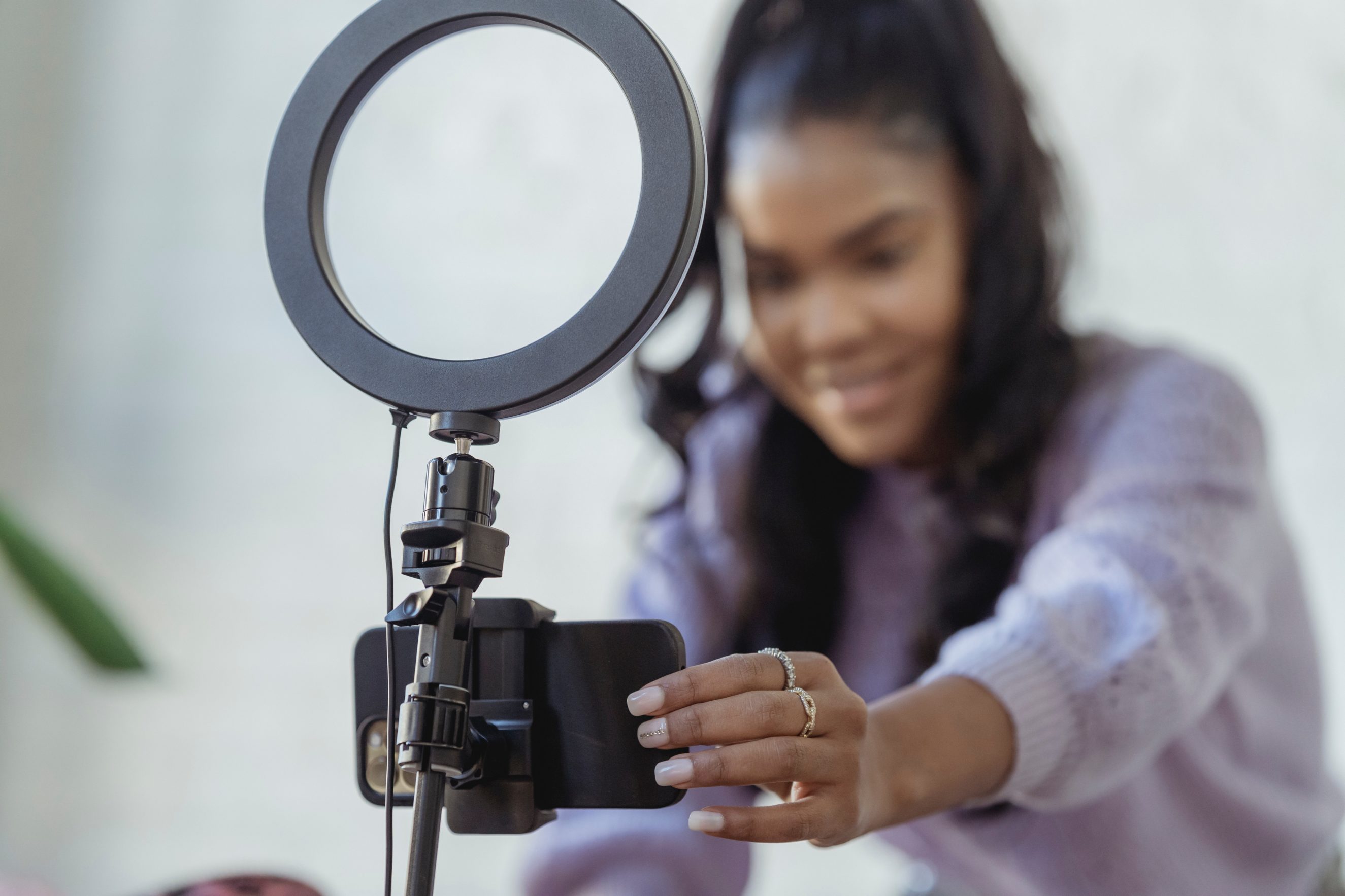 woman setting up phone and lighting