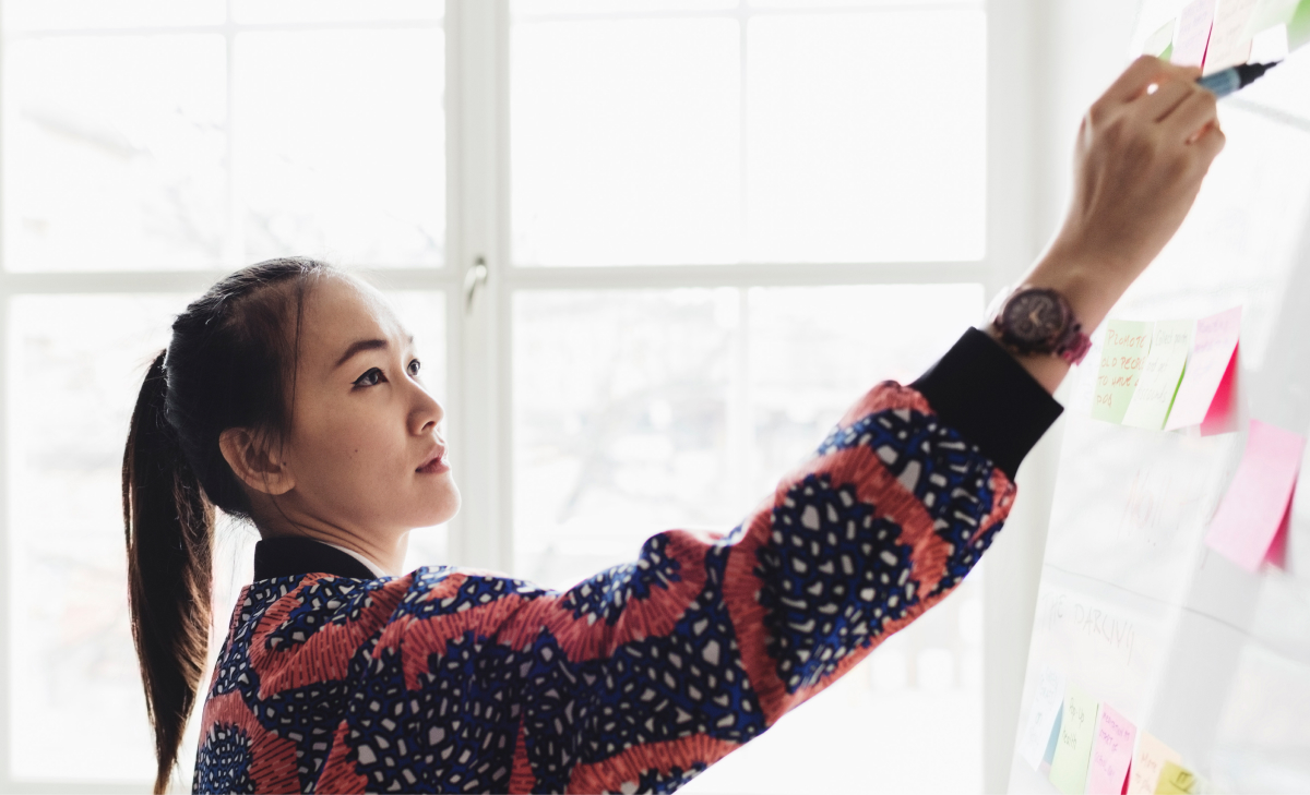 woman writing on board