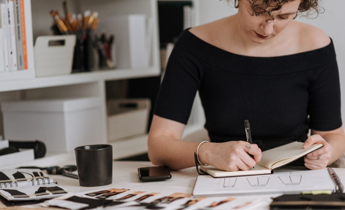 woman writing in notebook