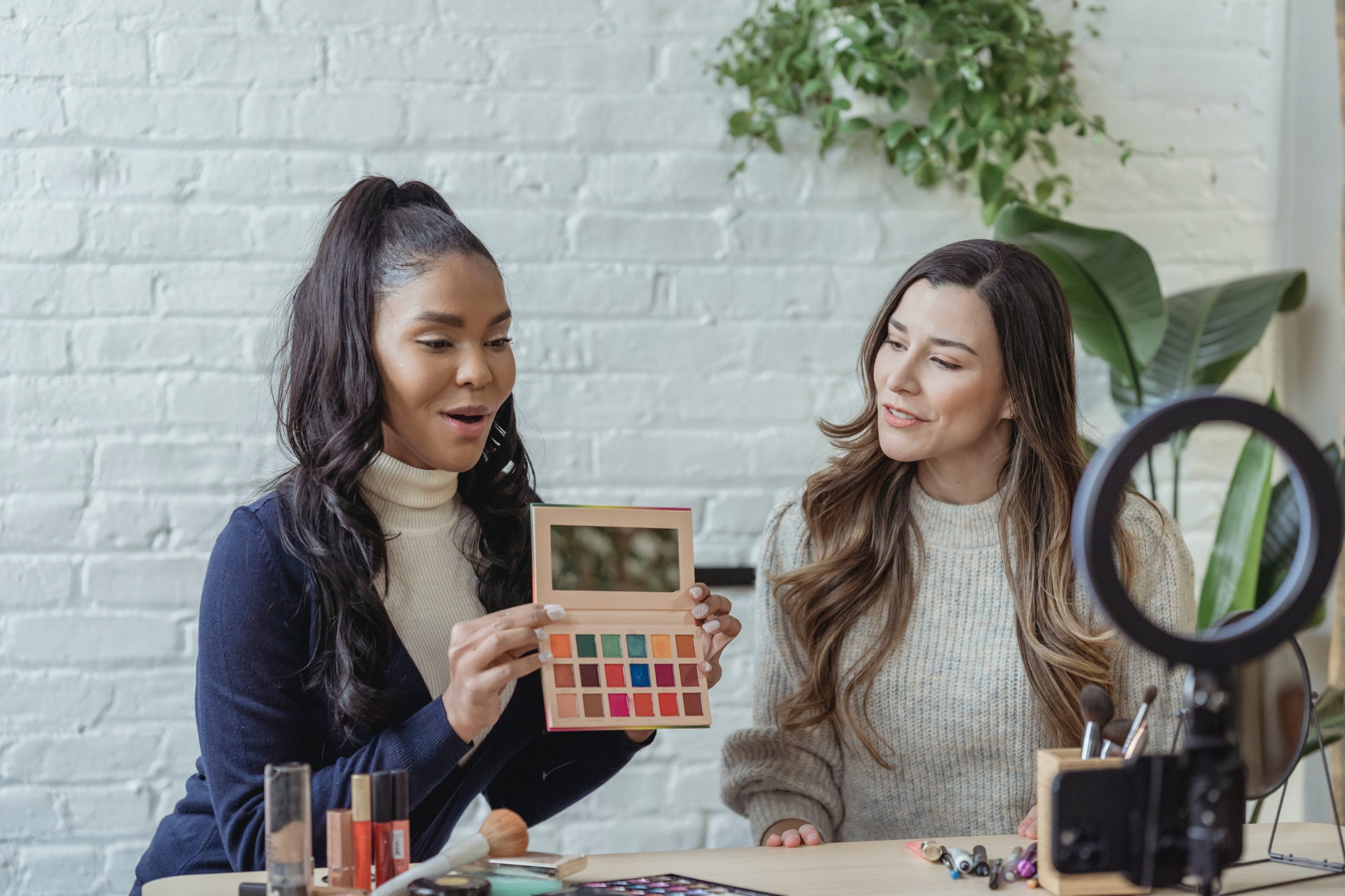 two girls filming makeup tutorial