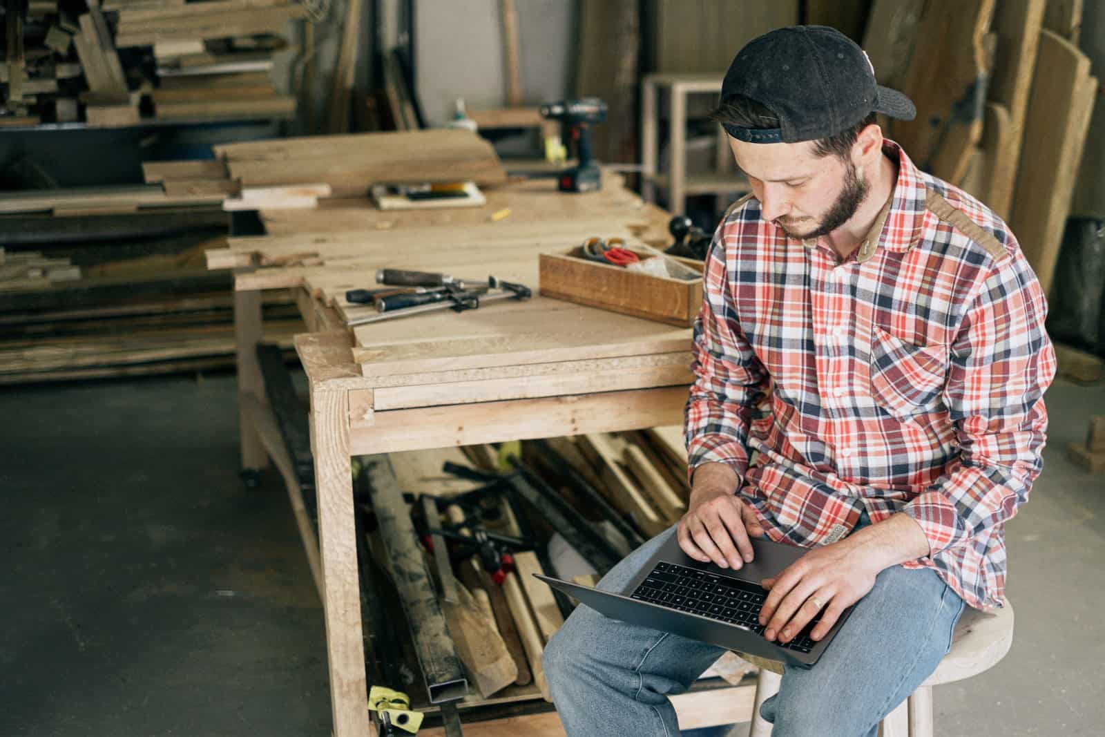 man on computer in workshop