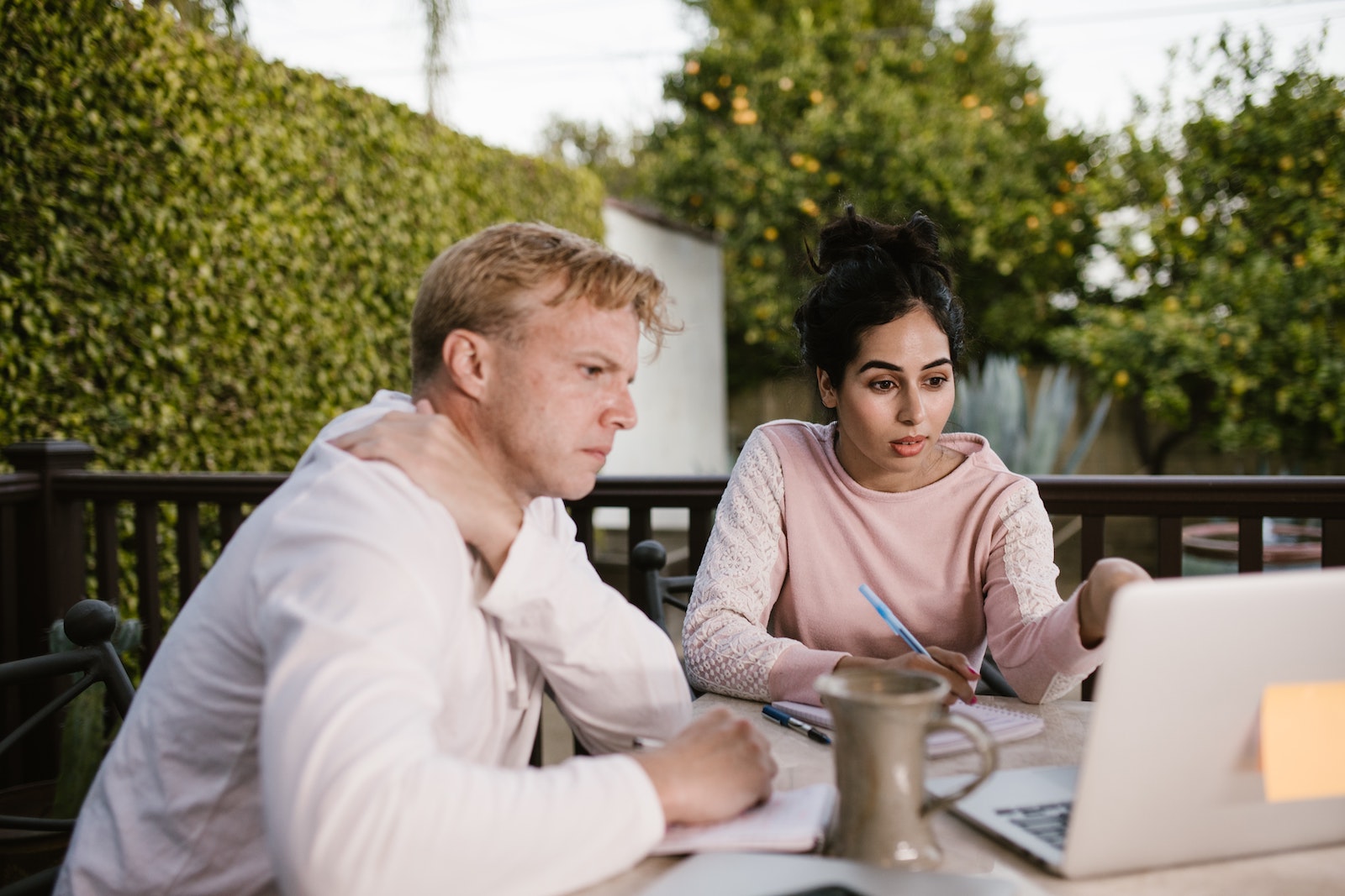 two people working at a computer outside