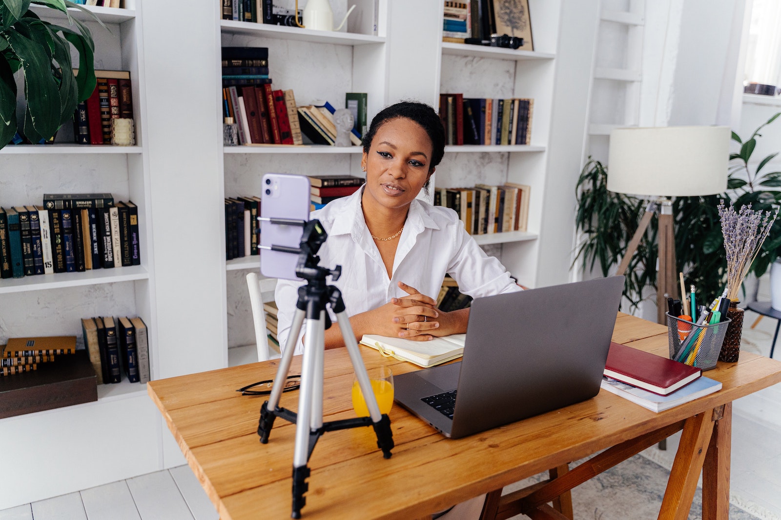 woman with tripod recording