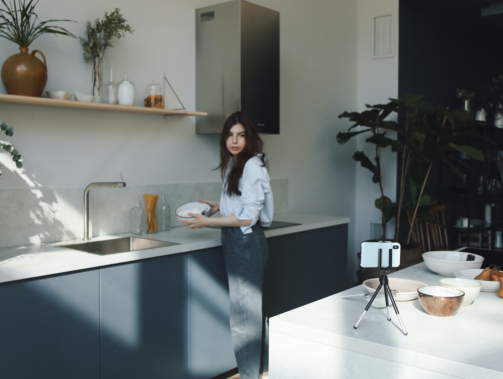 woman working in kitchen with iphone